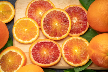 Orange fruit in wooden basket on wooden background, Red Blood orange with slice in wooden basket.