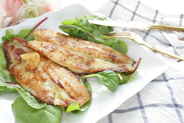 Homemade, butter sautéed fish fillet baby leaves salad