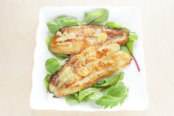 Homemade, butter sautéed fish fillet baby leaves salad