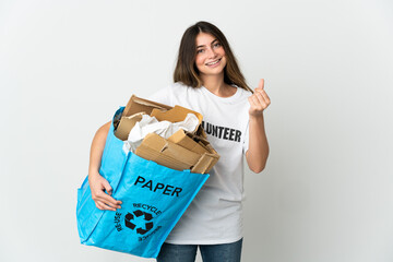 Young woman holding a recycling bag full of paper to recycle isolated on white background making money gesture