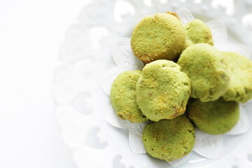 Pistachio cookie on white dish with copy space 