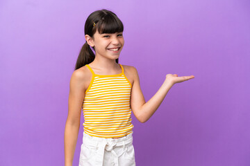 Little caucasian kid isolated on purple background holding copyspace imaginary on the palm to...
