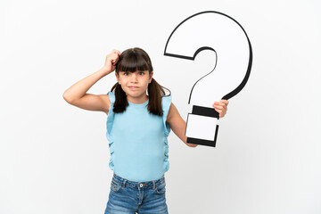 Little caucasian kid isolated on white background holding a question mark icon and having doubts
