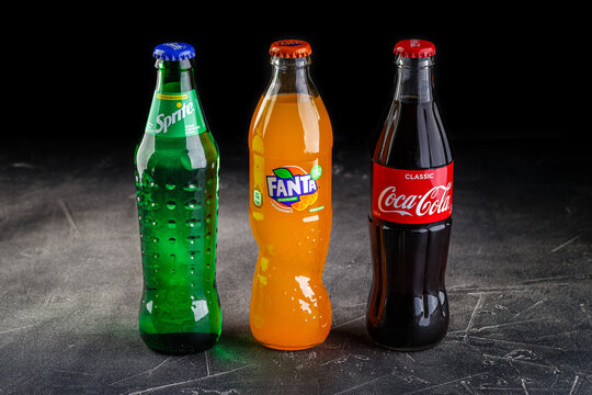 Glass bottles of Coca Cola and Fanta and Sprite soft drink.