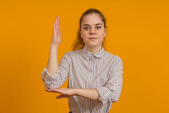 young girl teenager raised her hand to ask a question on a colored background