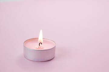 pink candle on a dark background