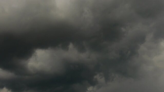 4K Time lapse, Gray and white rolling puffy clouds floating in the sky.