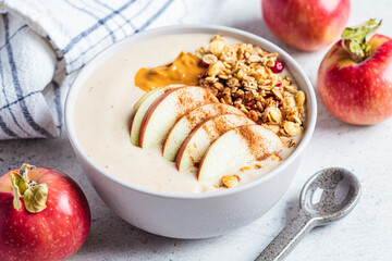 Apple pie smoothie bowl with granola and peanut butter. Vegan food.