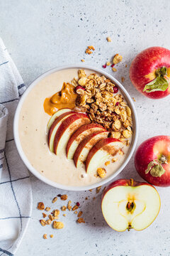 Apple pie smoothie bowl with granola and peanut butter. Vegan food.