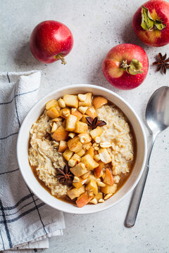 Autumn oatmeal with caramelized apple and cinnamon. Winter cozy recipe. Healthy comfort food.