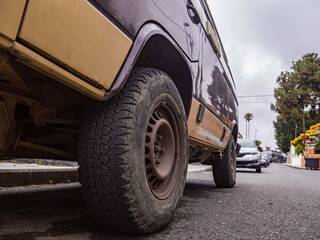 Modern crossover vehicle near old brick wall