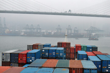 Container ship in port at container terminal. Ships of container ships stand in terminal of port on loading, unloading container.