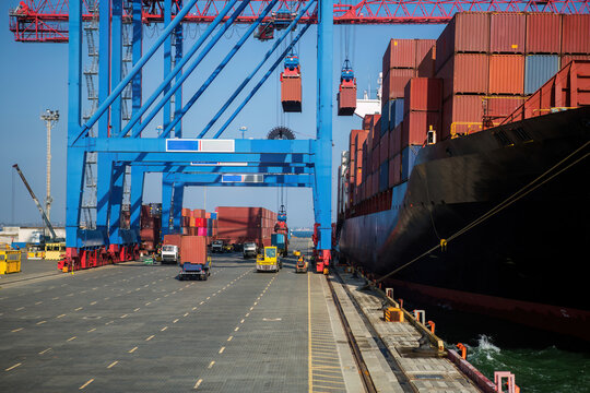 Container ship in port at container terminal. Ships of container ships stand in terminal of port on loading, unloading container.
