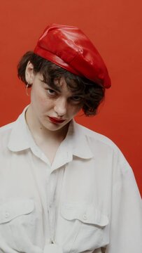 A brunette woman looks angrily from under her forehead with a cruel look