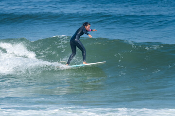 Surfer girl riding a wave