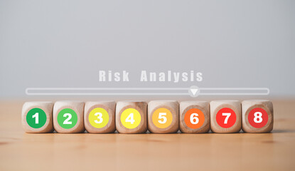 Risk rating from low to high number print on wooden cube block for risk assessment analysis and...