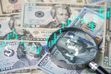 Closeup on magnifier glass with Benjamin Franklin on US dollar banknote and stock market graph for currency exchange and Interest rates concept. - obrazy, fototapety, plakaty