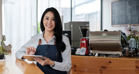 Startup successful small business owner sme beauty girl stand with tablet smartphone in coffee shop...