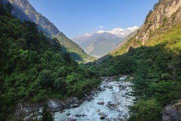 Fast mountain river in the Himalayas valley at sunrise