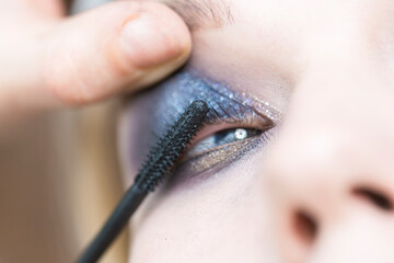 Close-up application of mascara. Eye makeup.