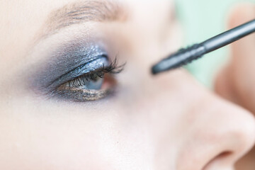 Eye makeup close-up. Mascara application.