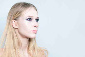 Naklejka premium Portrait of a blond girl with beautiful make up isolated on white background.