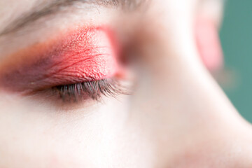 Fototapeta premium Red eyeshadow. Close up of a girl's closed eye.