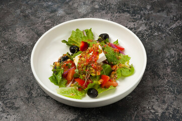 vegetable salad with pickled cheese on a white plate in a restaurant