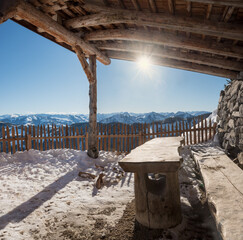 wooden shelter with table, picnic place at hartkaiser mountain, winter landscape tirol