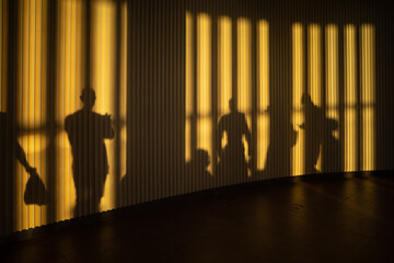 Corfu, Greece, People in-line and in shadow at the airport gate at  sunset.