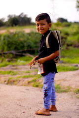 Young smiling happy male kid school boy 5-6 years old in shirt backpack look camera outdoor view,childhood children kids education lifestyle concept.