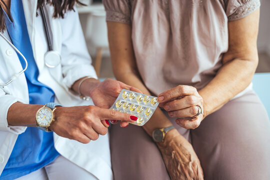 Doctor prescribes medication to the senior patient. Female doctor giving pills bottle to senior female patient in clinic. Concept of healthcare, medical treatment and insurance.