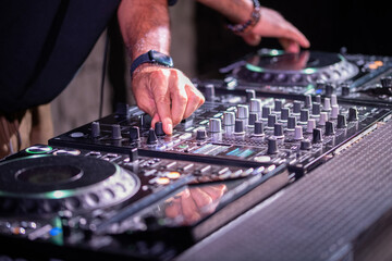 Obraz premium Dj playing disco house progressive electro music at the concert. DJ hands on equipment