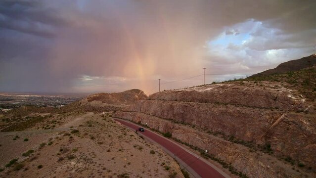 Ascending over McKellington Canyon in El Paso, Texas to see a rainshower casting a rainbow.