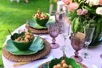 table set with flowers and pitombas regional fruits

