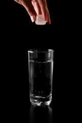 Glass of water filled with ice cubes