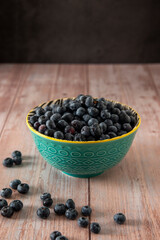 Blueberries in a bowl on wooden table