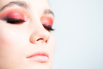 Fototapeta premium Bright red eye makeup close-up. On a white background.
