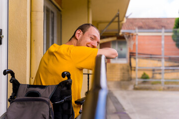 Disabled person dressed in yellow in a wheelchair at school smiling