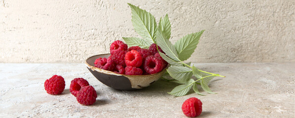 bowl with raspberries on a light table, space for text