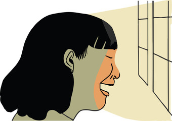 An Asian woman looks out of the window as warm light hits her face. 