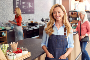 Portrait Of Female Owner Or Worker In Coffee Shop Or Restaurant