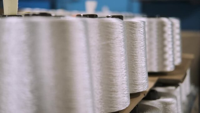 production of fiberglass yarn. Finished fiberglass spools are awaiting inspection and packaging. fiberglass spools ready for sale