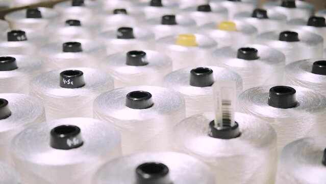 production of fiberglass yarn. Finished fiberglass spools are awaiting inspection and packaging. fiberglass spools ready for sale
