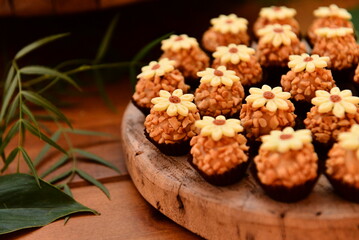 sweets decorated with flowers on party table, candy store, condensed milk candy balls, candy balls