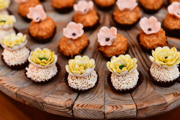 sweets decorated with flowers on party table, candy store, condensed milk candy balls, candy balls