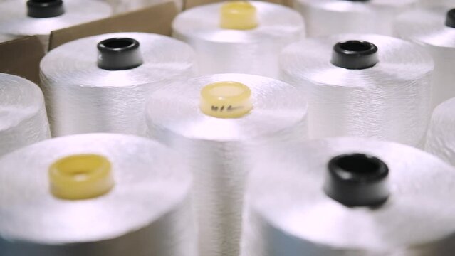 production of fiberglass yarn. Finished fiberglass spools are awaiting inspection and packaging. fiberglass spools ready for sale