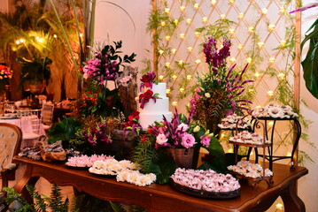 Fototapeta na wymiar luxury cake and candy table decorated with colorful roses, condensed milk candy balls, candy balls