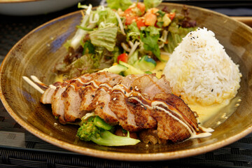 Asian food, close up of Asian roasted duck breast with rice, vegetables and coconut sauce.