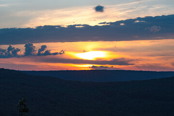 sunset in the mountains, cloudscape iluminated by the sun